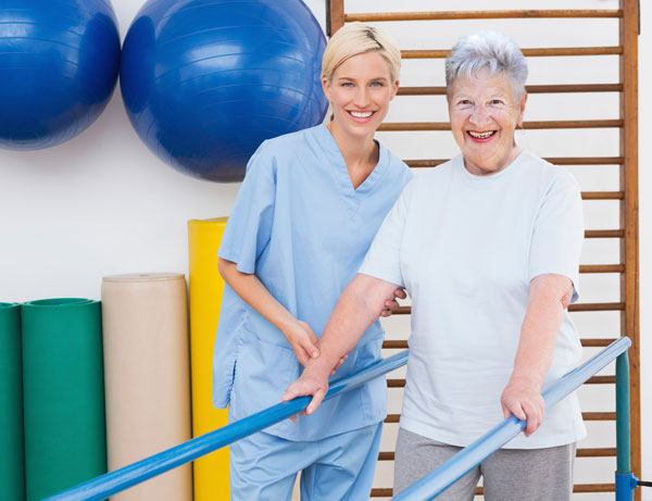 Patient and caregiver in a therapy setting, smiling together.