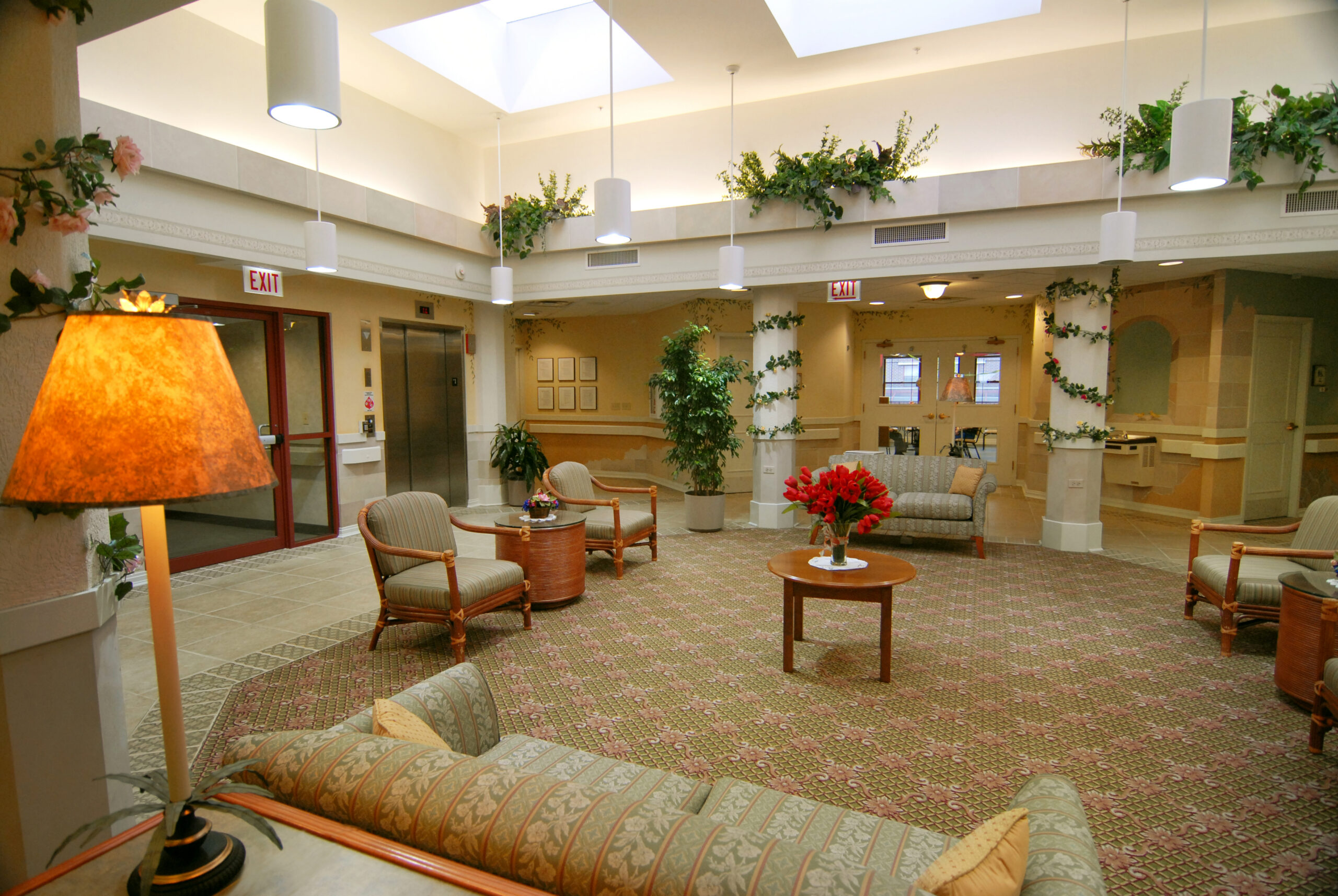 Bright, welcoming lobby with seating and greenery.