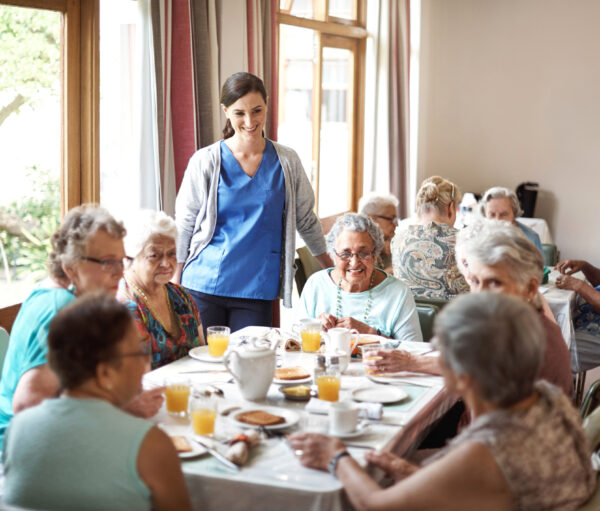Shot of a group of seniors enjoying breakfast together in their retirement home