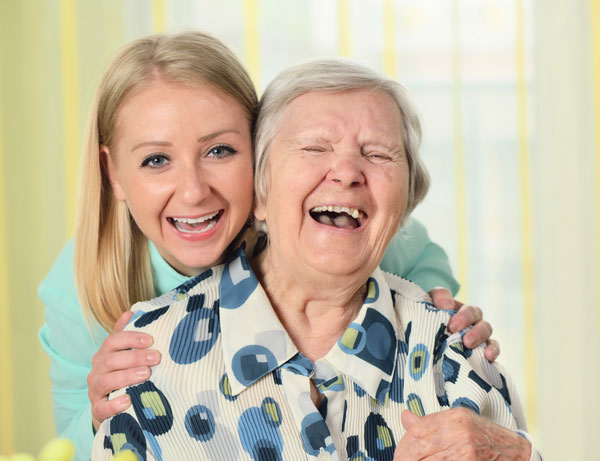 Young woman and elderly woman laughing